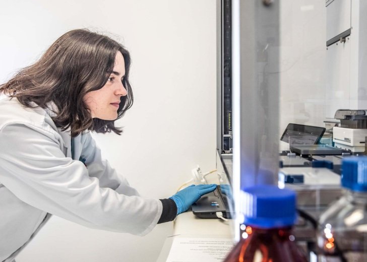 Female researcher watches scientific equipment