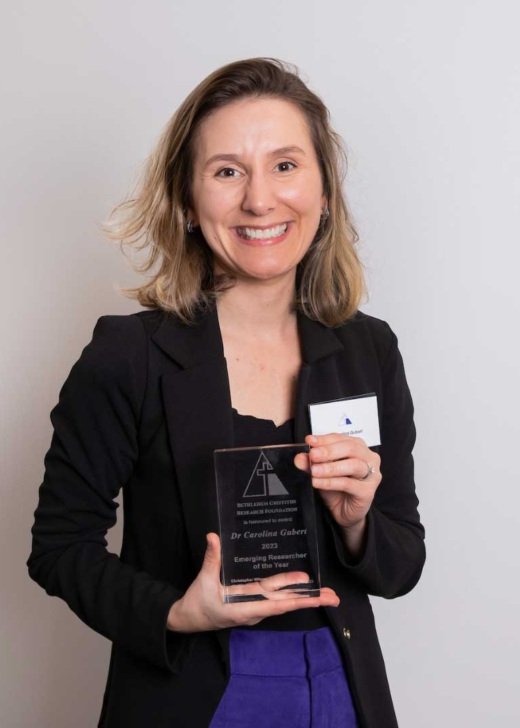 Dr Carolina Gubert holding her Bethlehem Griffiths Research Foundation medal.