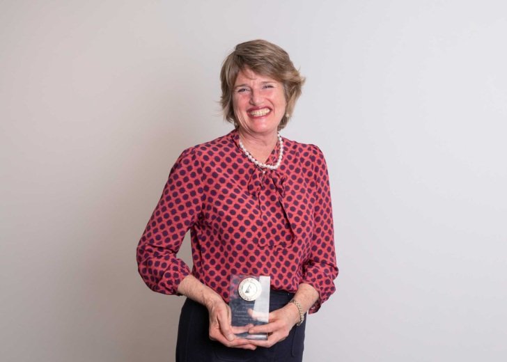 Professor Catriona McLean AO holding her Bethlehem Griffiths Research Foundation medal.