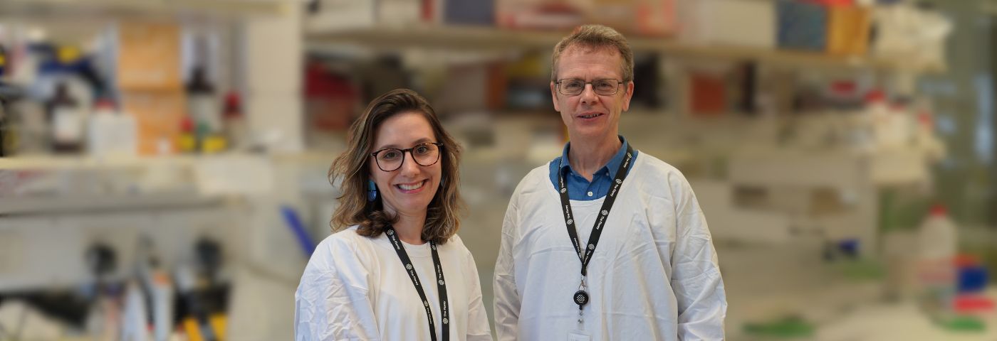 A woman and male scientist wearing white lab coats and standing in a Florey laboratory