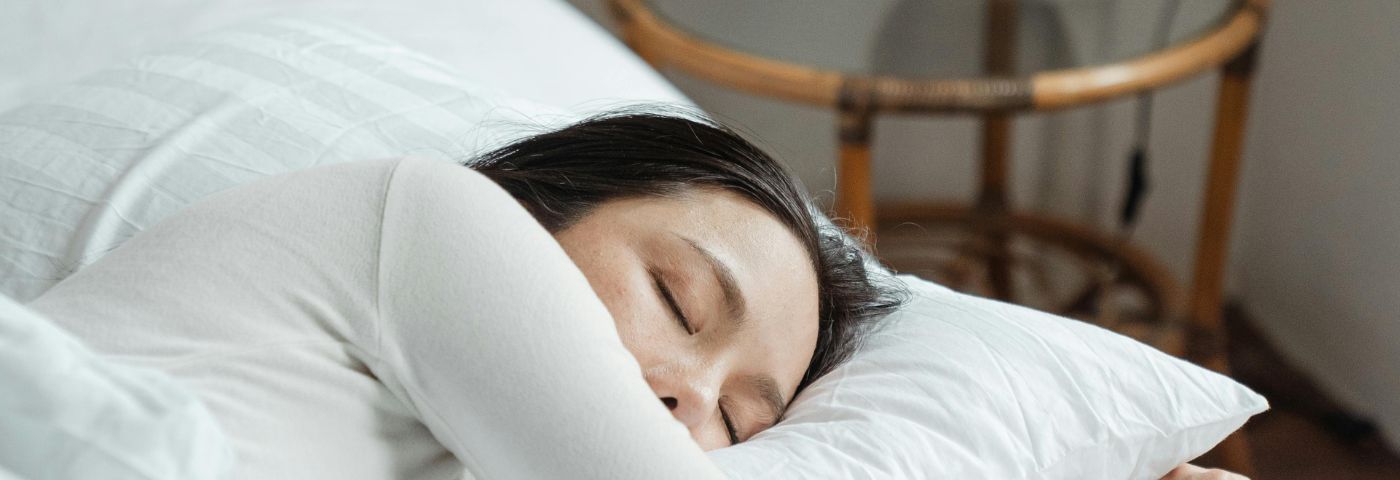 Woman lying asleep in bed