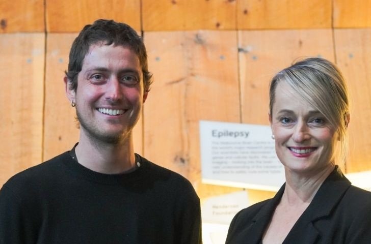 Dr Carlos Gantner and Tania West smile for photo in reception area of The Florey.