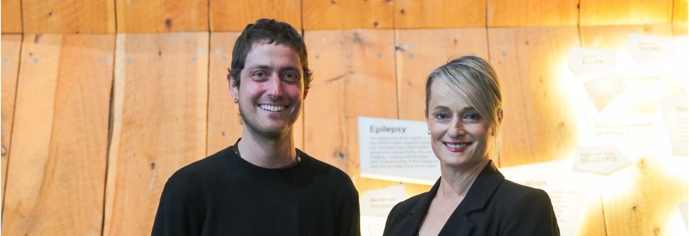 Dr Carlos Gantner and Tania West smile for photo in reception area of The Florey.