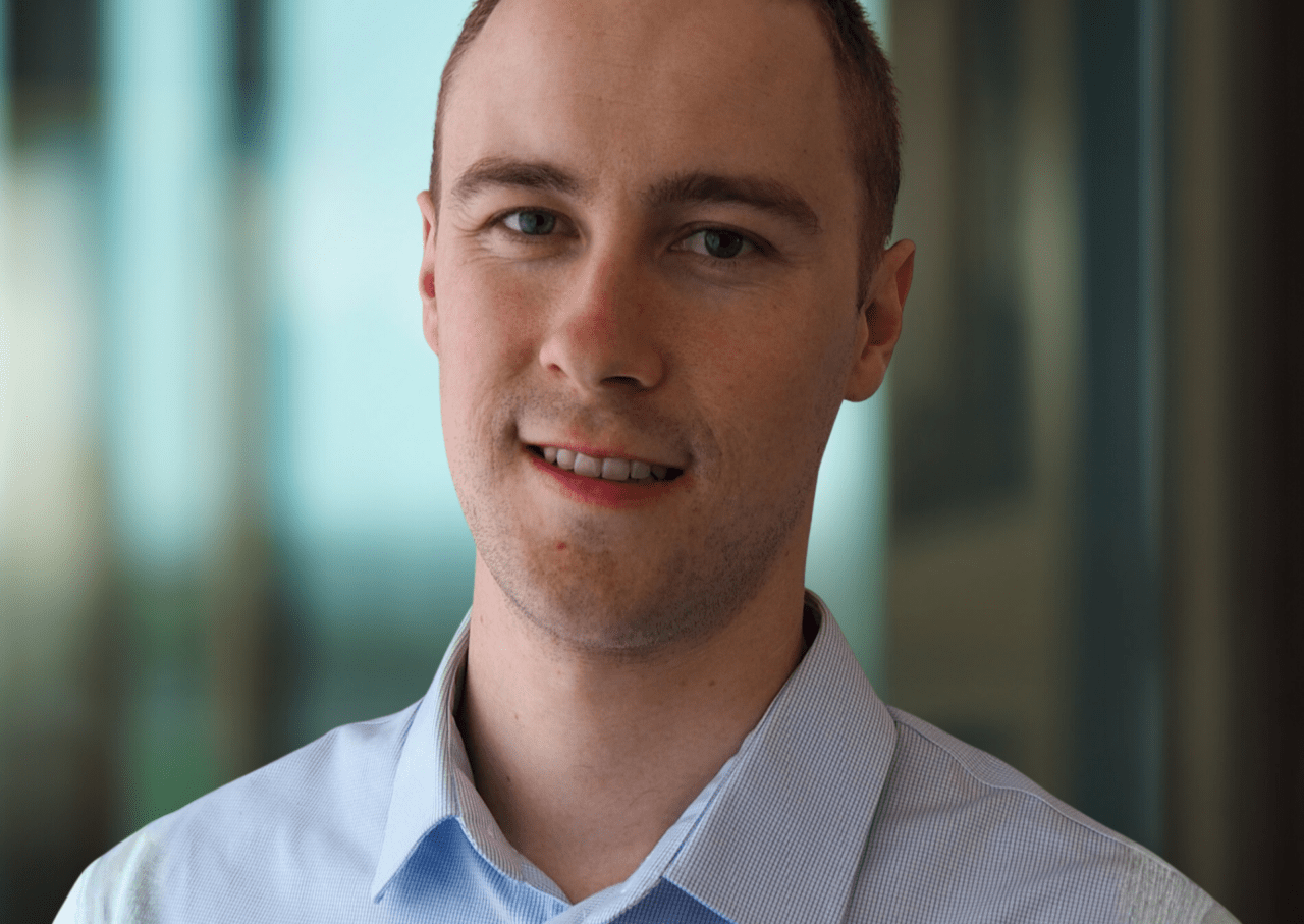 Young man wearing blue shirt smiles