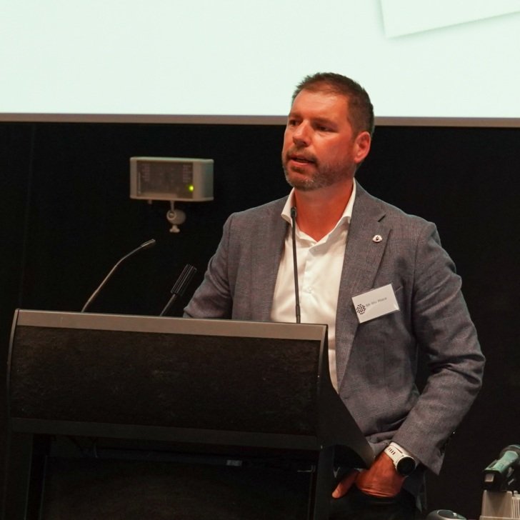 Man stands at podium in auditorium