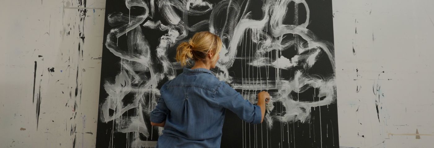 Woman paints large canvas