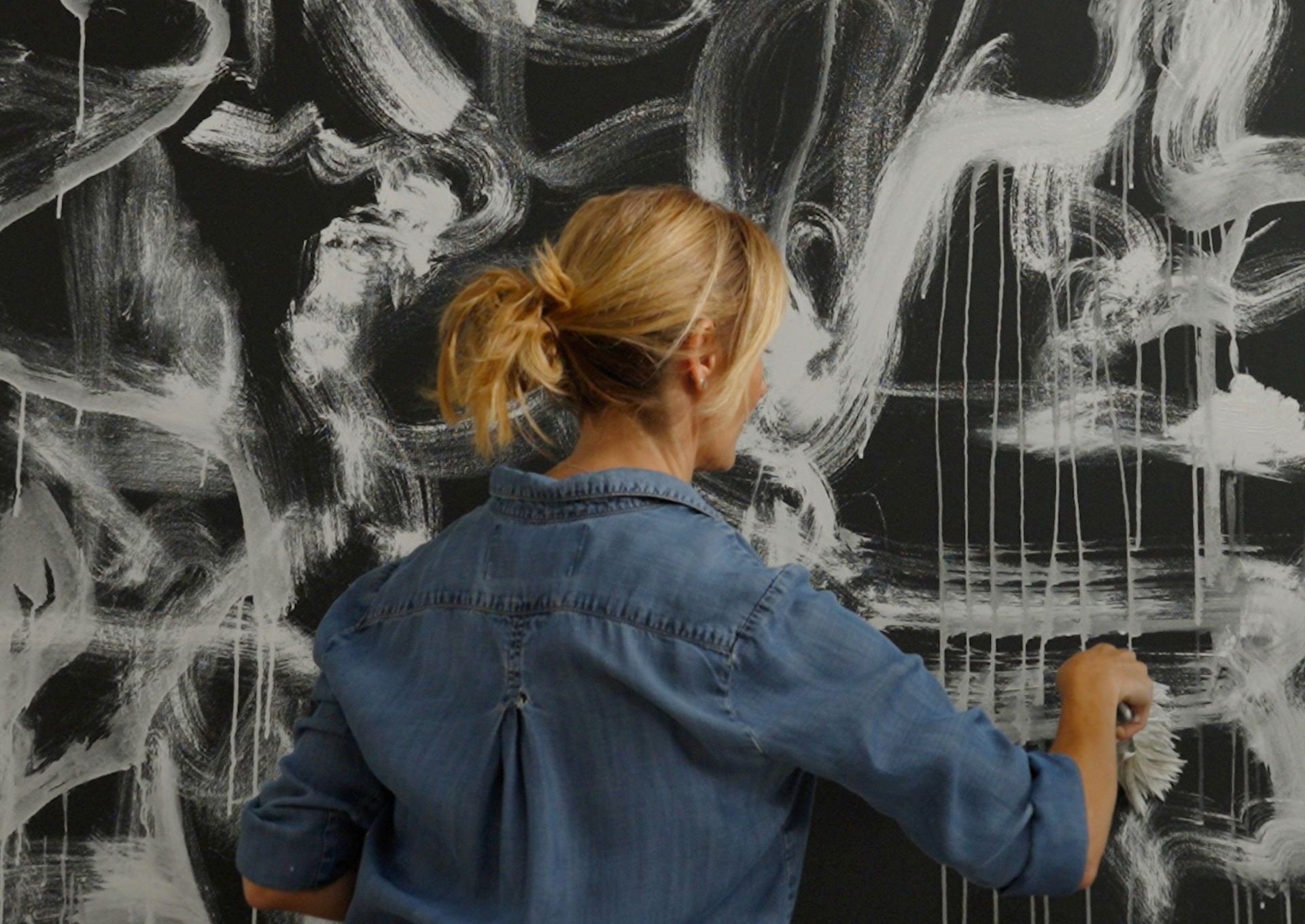 Woman painting canvas