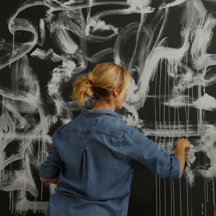 Woman painting canvas
