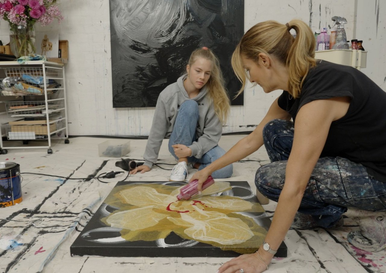 Young student and artist work on a canvas painting in an art studio