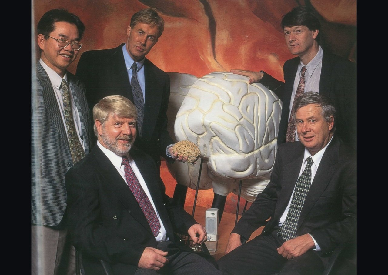 Five men stand around model of human brain.
