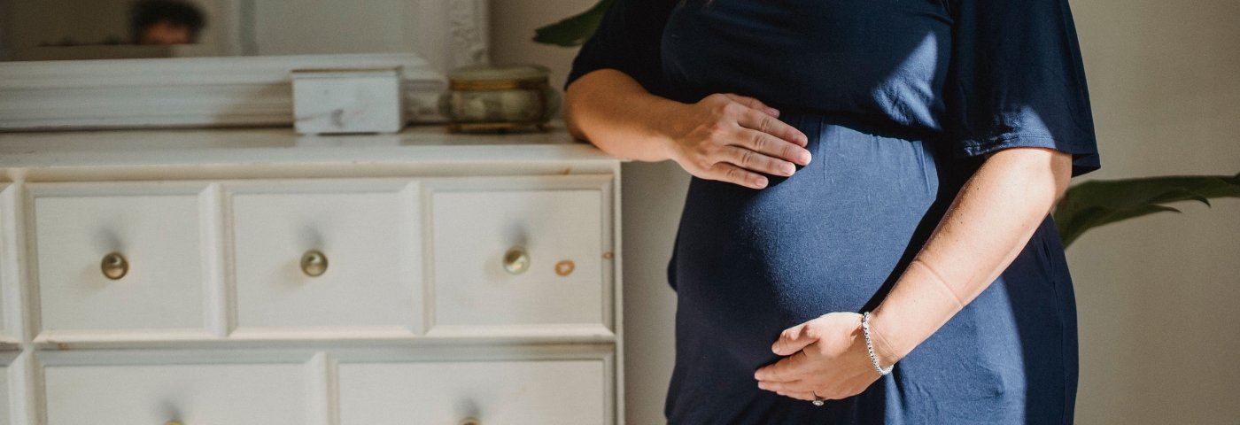 Pregnant woman holds her belly